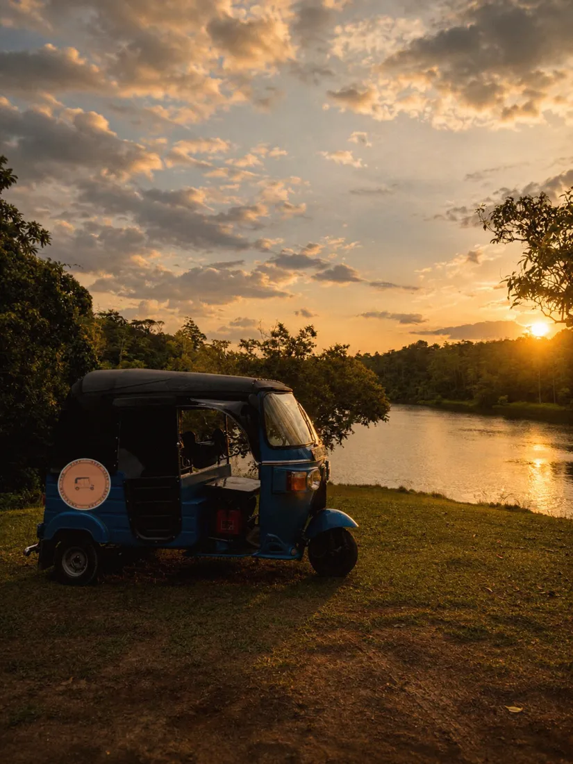 Blue tuk-tuk at golden hour with the Tuk & Tide door decal